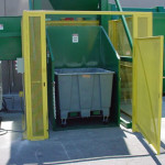 Dumper feed with free-standing safety enclosure.