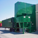 Wall mount side feed CP155FW with a drop clean-out chute into a clean-out container feeding a walking floor trailer.